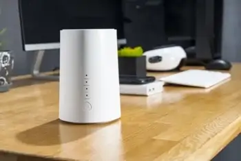 A white modem displayed on a desk